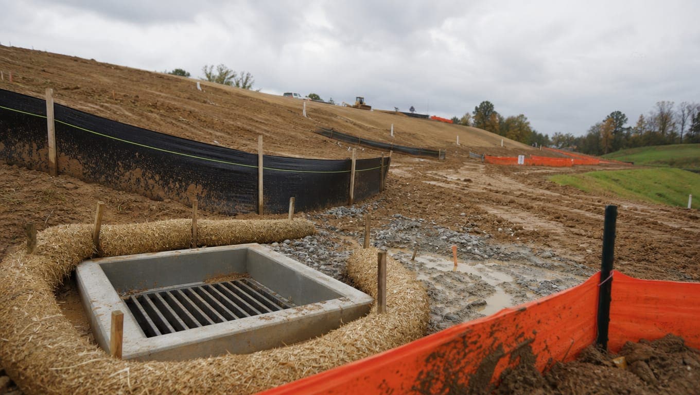 Construction site SWPPP erosion controls including silt fence and inlet protection on graded slopes with stormwater BMP sequencing visible